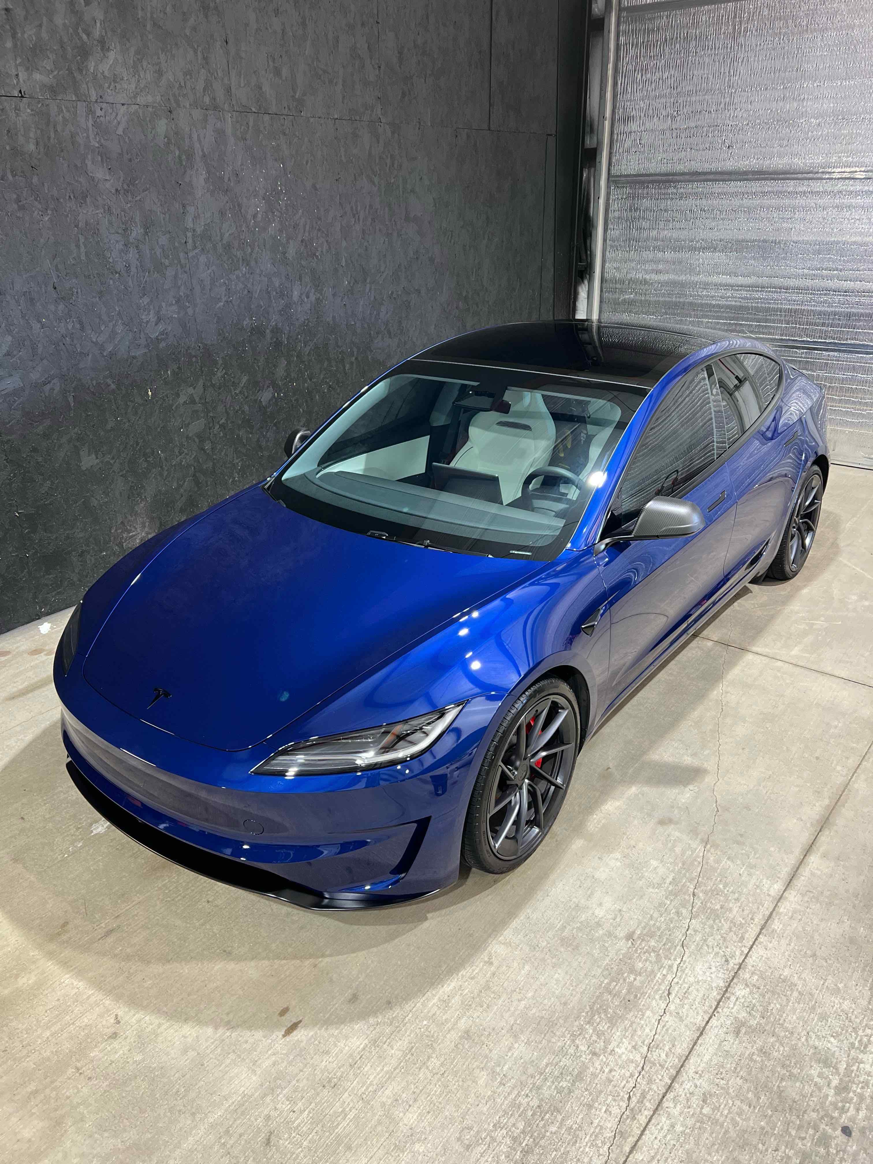 Exterior detailing result on a deep blue Tesla Model 3 - mirror-gloss paint finish after full exterior detail, Premier Auto Detailing Salina KS