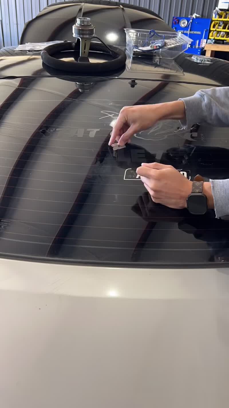 Paint correction in progress - machine polisher removing swirl marks from a black hood, Premier Auto Detailing Salina KS